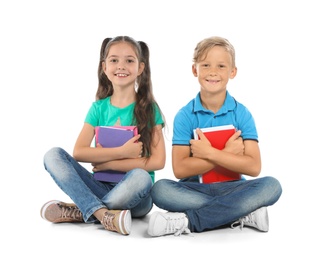 Little children with school supplies on white background