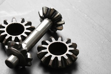 Different stainless steel gears on light grey background, closeup. Space for text