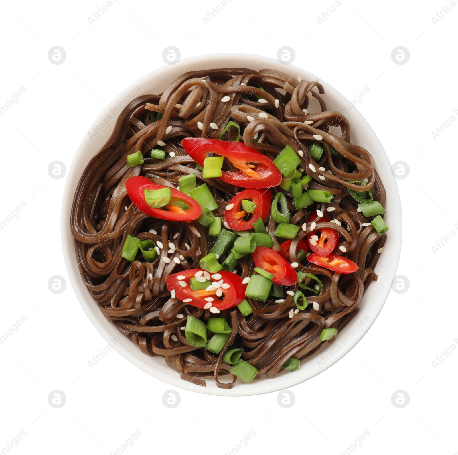 Photo of Tasty buckwheat noodles (soba) with chili pepper and onion in bowl isolated on white, top view