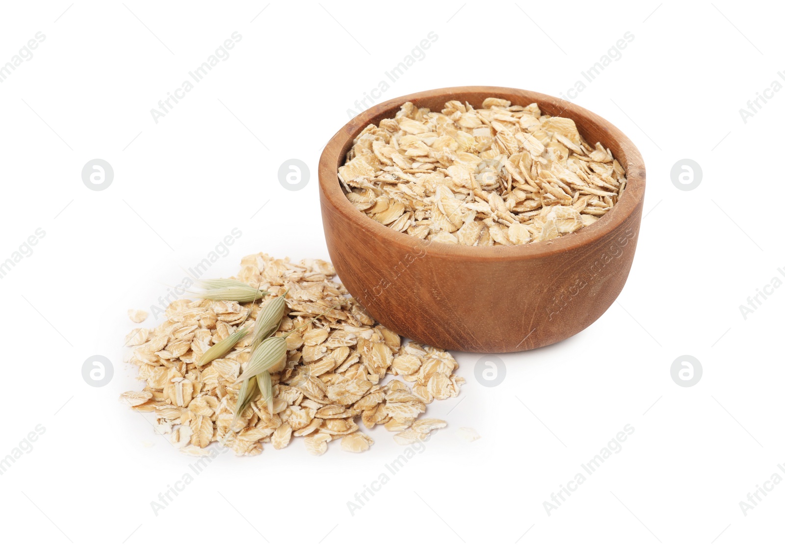 Photo of Wooden bowl with oatmeal and florets isolated on white