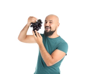 Overweight man with grapes on white background