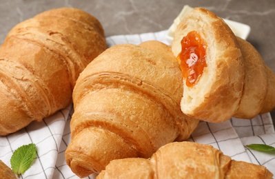 Photo of Tasty croissants with jam, closeup
