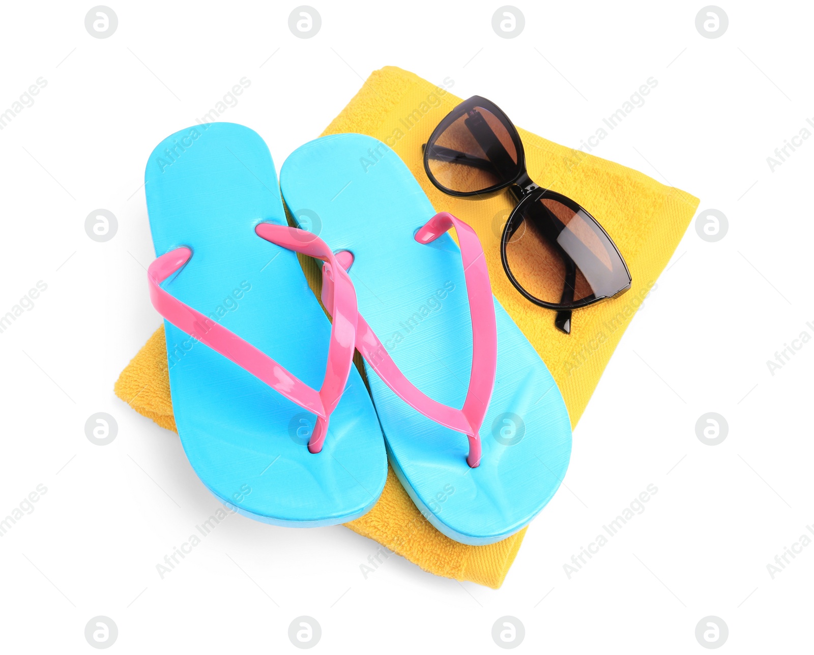 Photo of Yellow terry towel, sunglasses and flip flops isolated on white. Beach objects