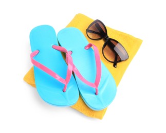 Photo of Yellow terry towel, sunglasses and flip flops isolated on white. Beach objects
