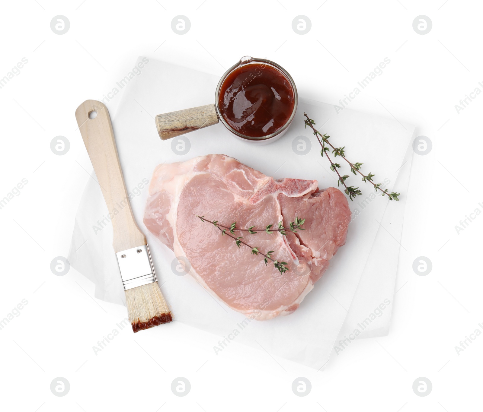 Photo of Raw meat, thyme, basting brush and marinade isolated on white, top view