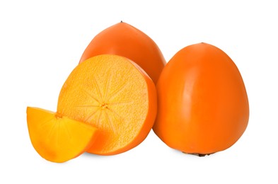 Whole and cut delicious ripe juicy persimmons on white background