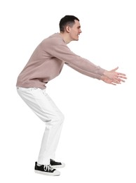 Photo of Handsome young man greeting someone on white background