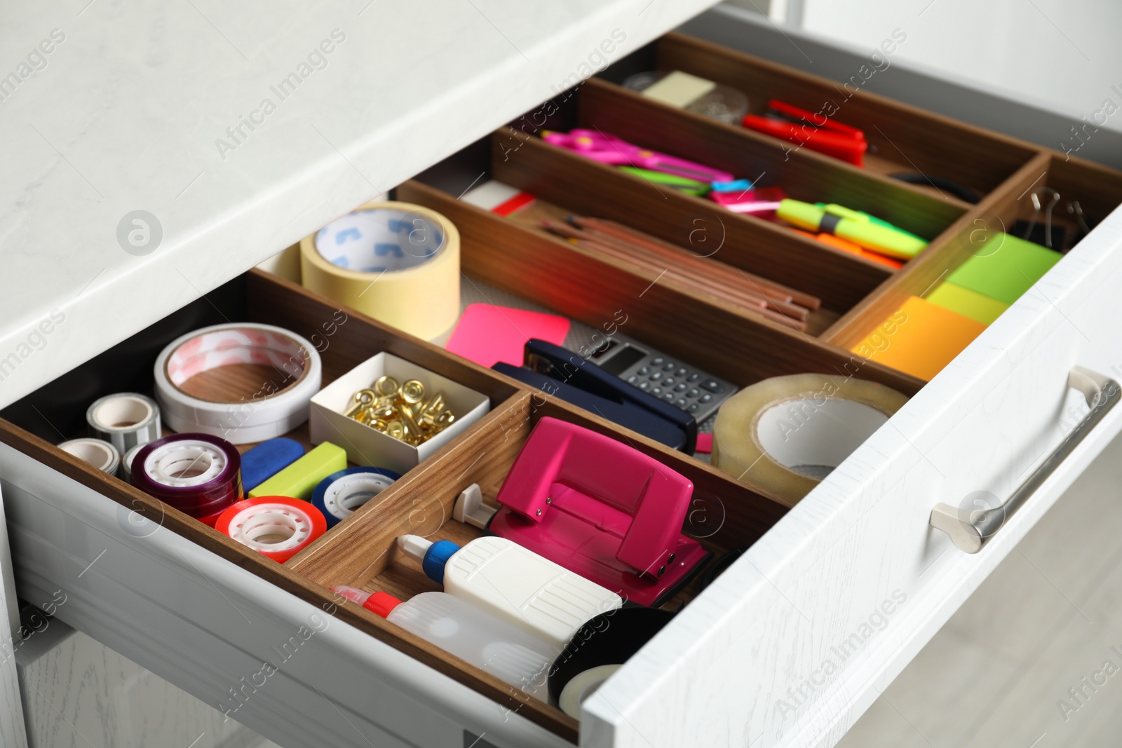 Photo of Different stationery in open desk drawer indoors, closeup