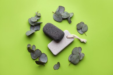 Flat lay composition with pumice stones on light green background