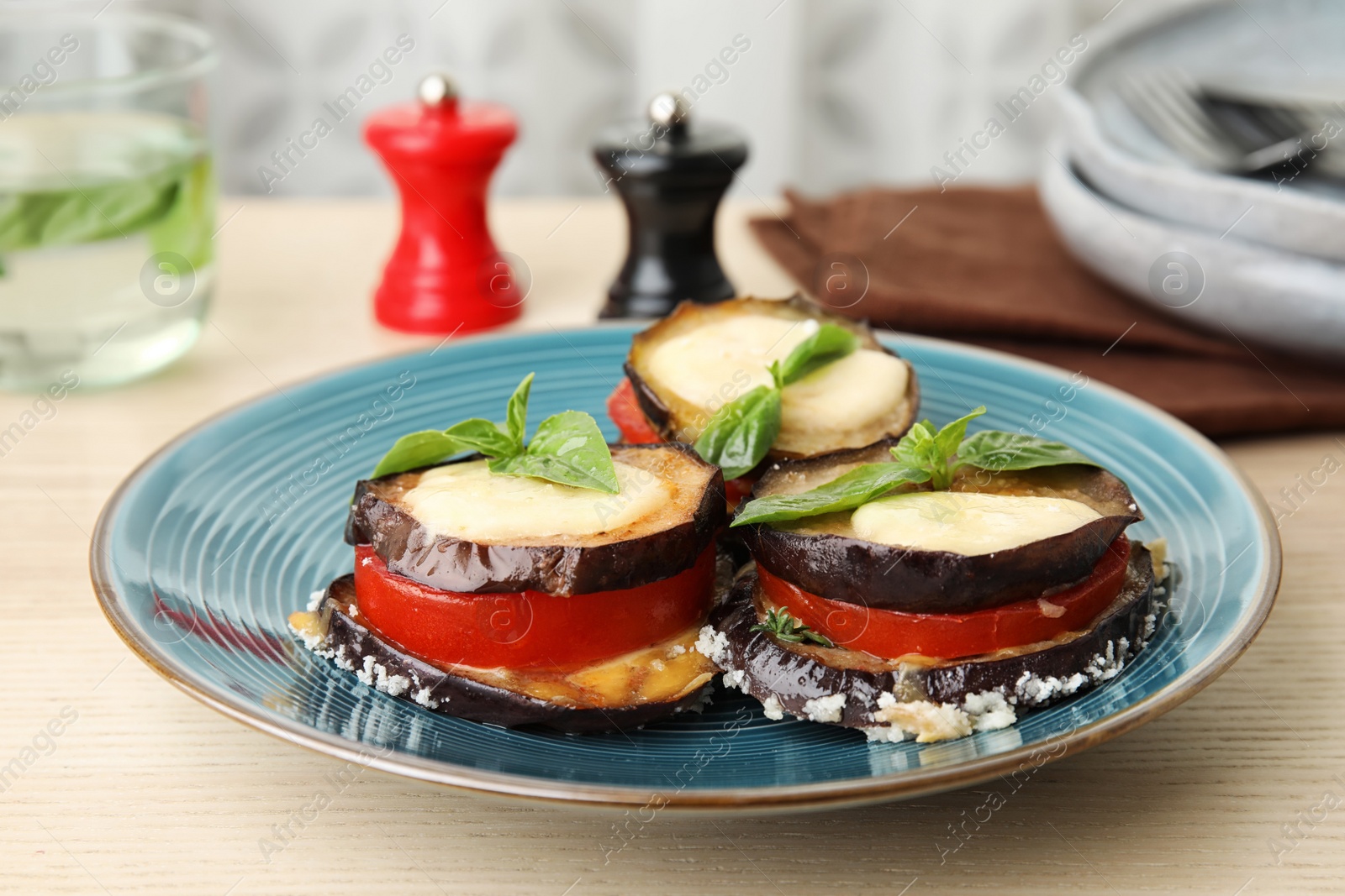 Photo of Baked eggplant with tomatoes, cheese and basil on table