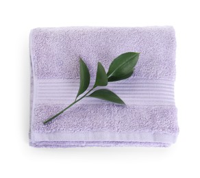 Photo of Folded violet terry towel and branch isolated on white, top view