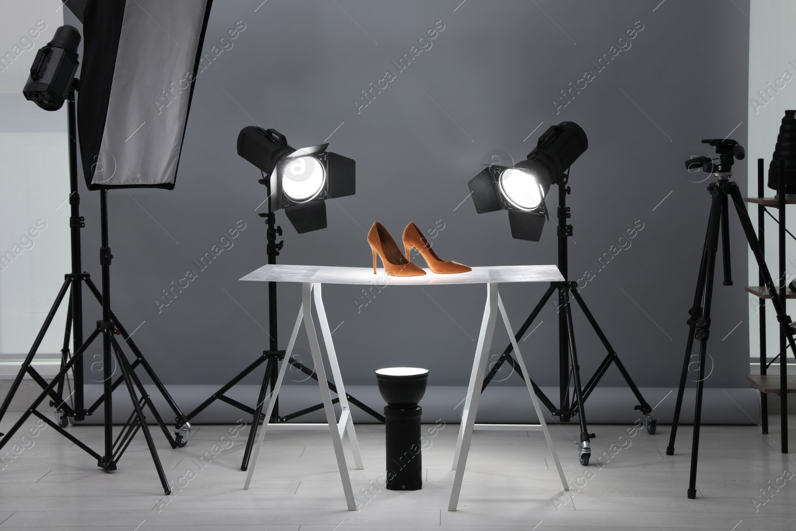 Photo of Professional photography equipment prepared for shooting stylish shoes in studio