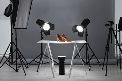 Photo of Professional photography equipment prepared for shooting stylish shoes in studio