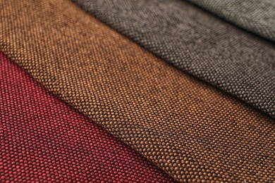 Photo of Fabric samples of different colors for interior design as background