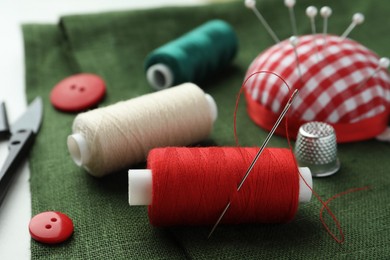 Threads and other sewing supplies on table