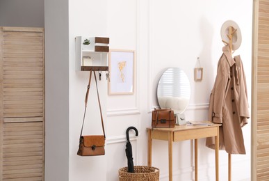 Photo of Modern hallway interior with stylish dressing table and key holder
