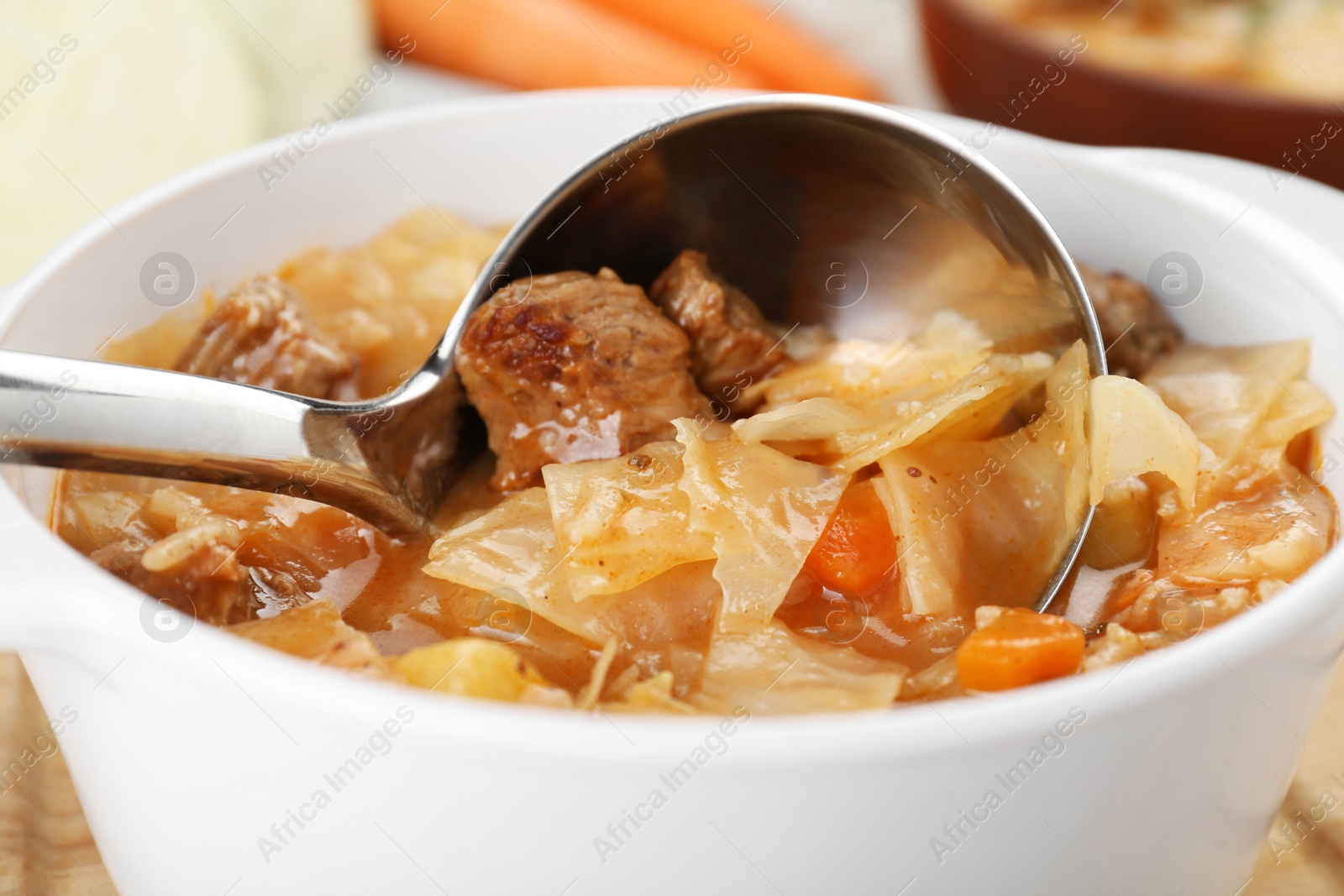 Photo of Tasty cabbage soup with meat and carrot, closeup