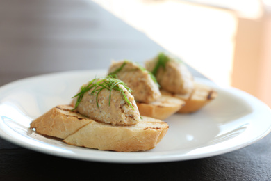 Photo of Delicious bruschettas with tuna pate on plate, closeup