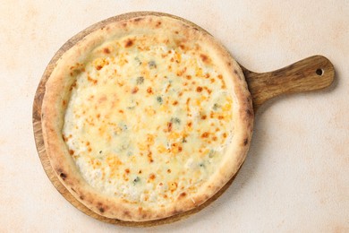 Photo of Delicious cheese pizza on beige textured table, top view