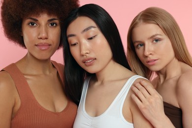 Portrait of beautiful young women on pink background