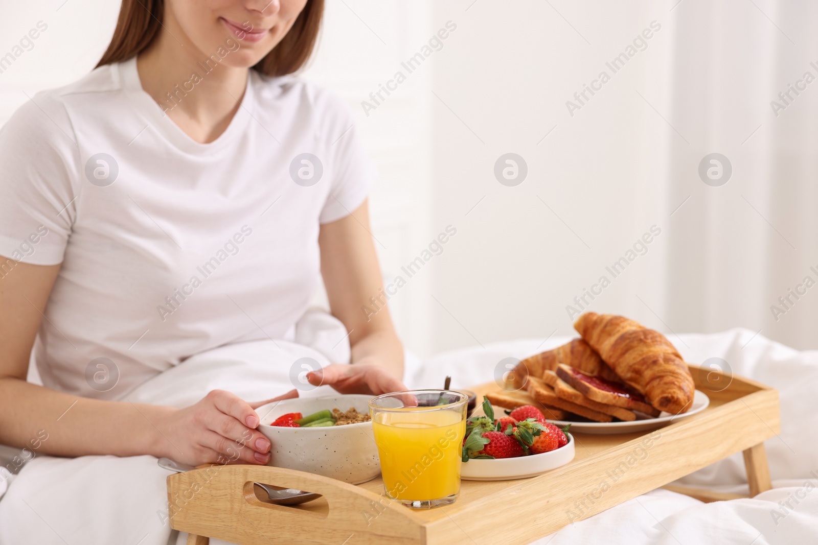 Photo of Woman having breakfast in bed, closeup. Space for text