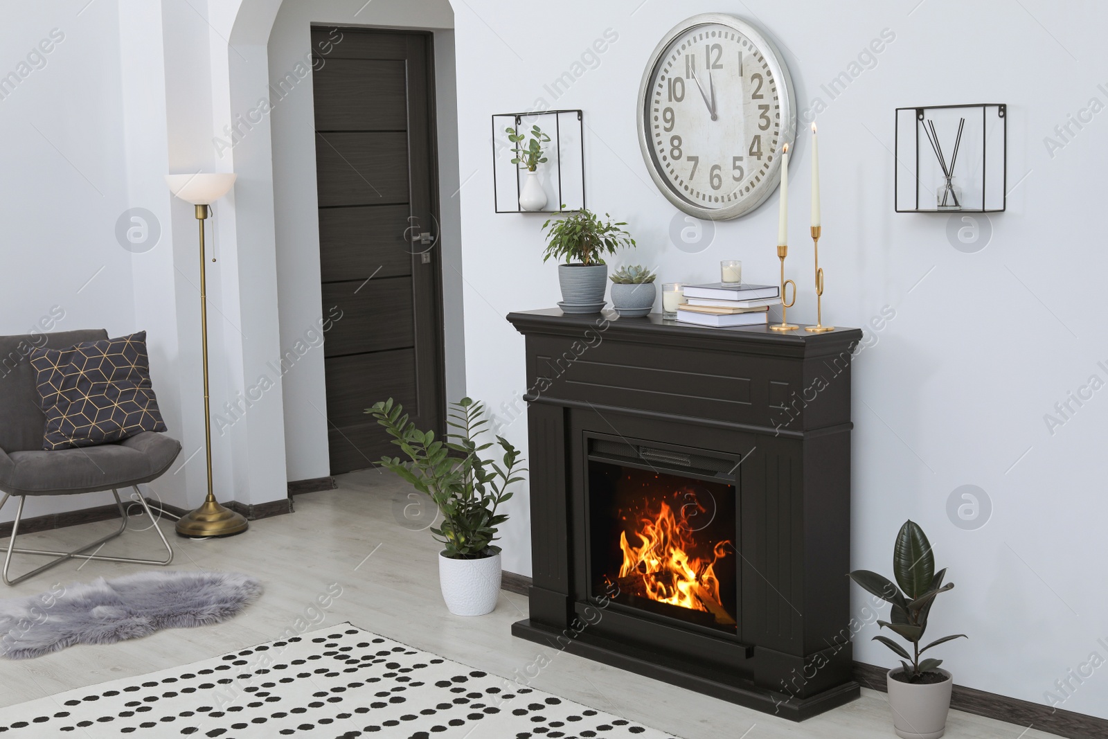 Photo of Stylish living room interior with fireplace and green plants