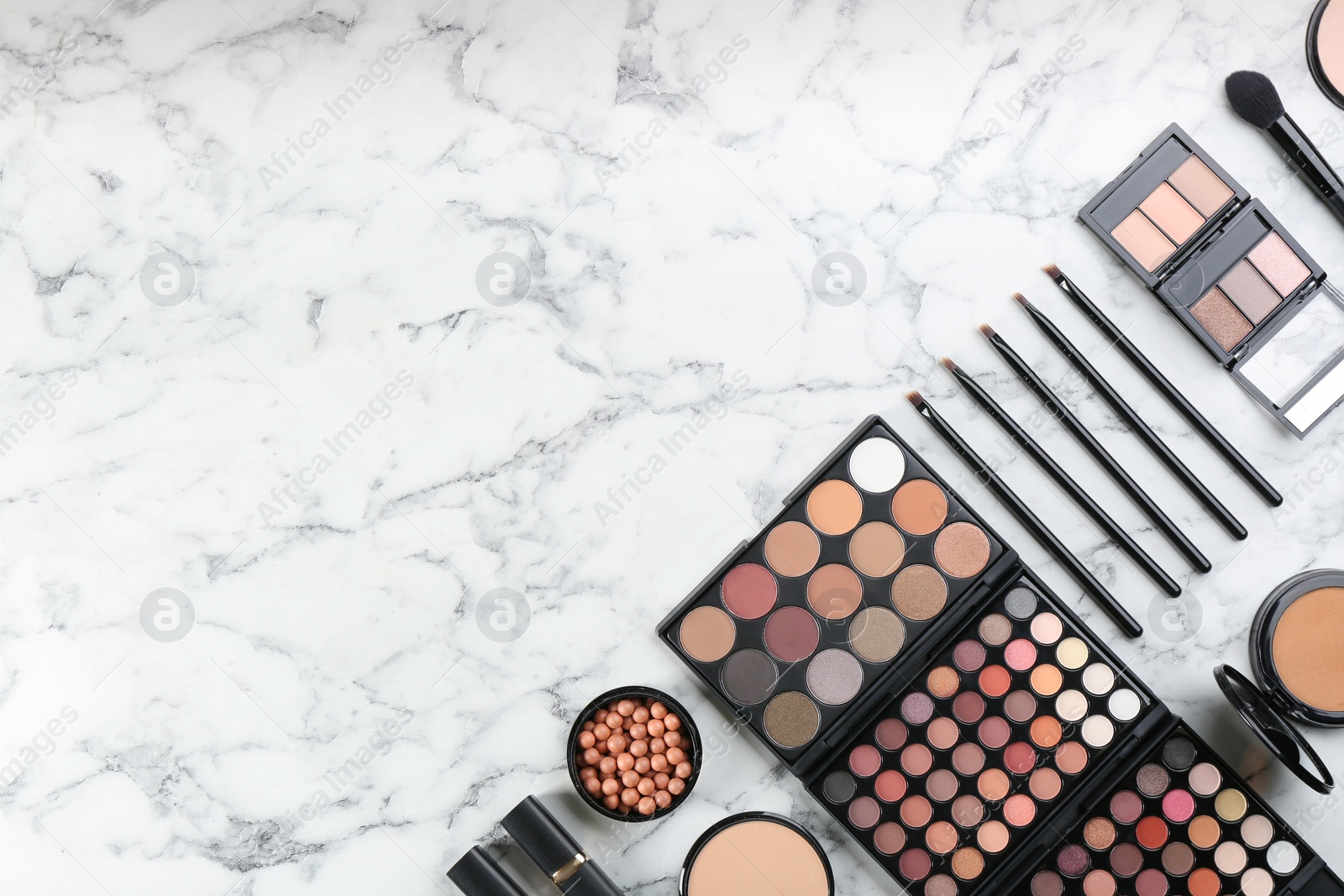 Photo of Flat lay composition with makeup brushes on white marble table, space for text