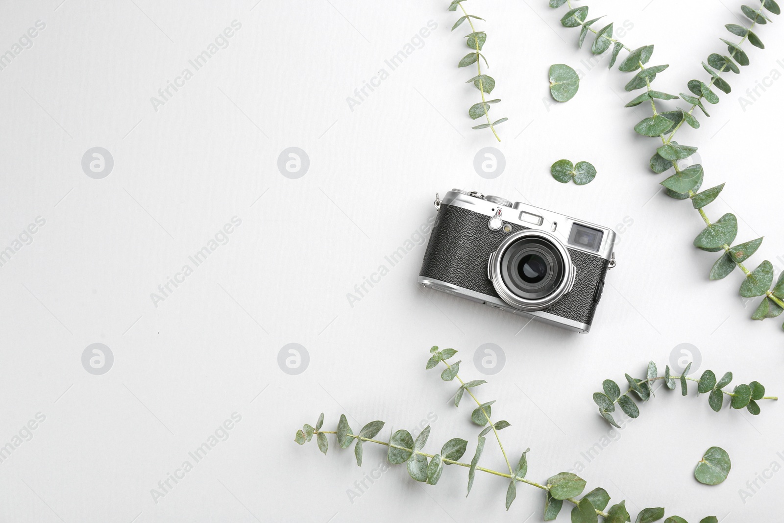 Photo of Flat lay composition with camera for professional photographer on light background, top view