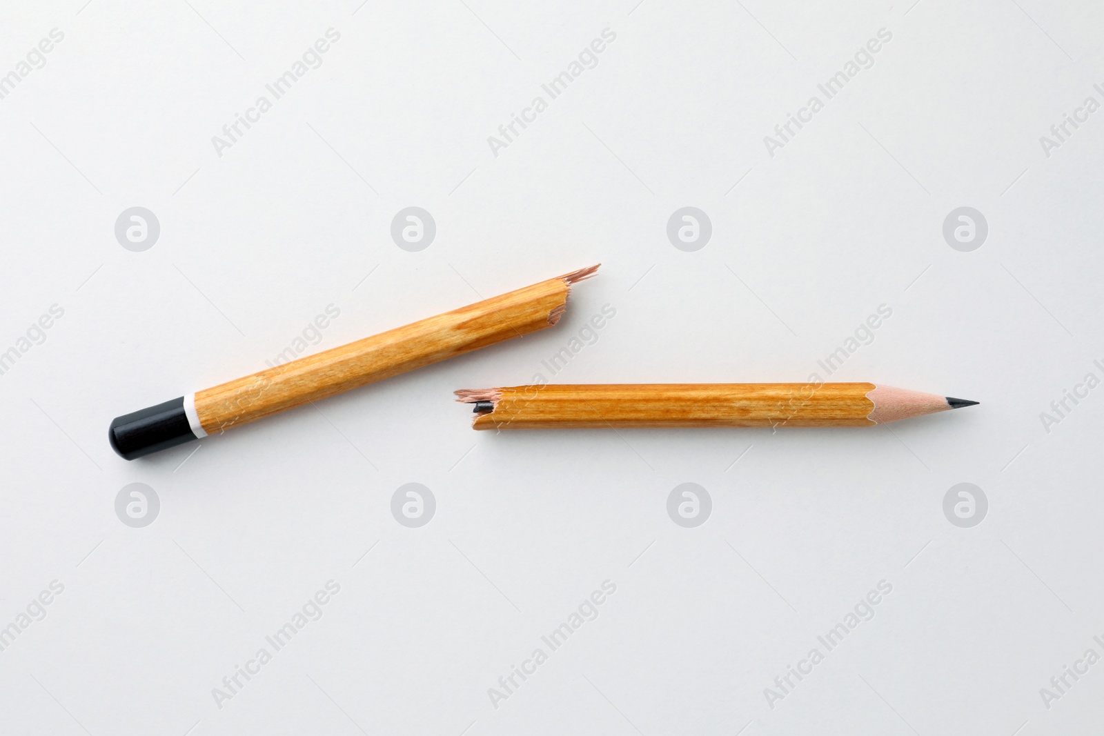 Photo of Broken pencil on white background, flat lay