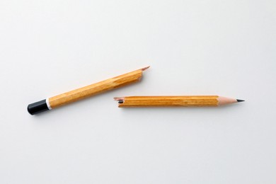 Broken pencil on white background, flat lay