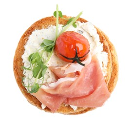 Photo of Tasty rusk with prosciutto, cream cheese and tomato on white background, top view