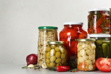 Photo of Jars of pickled vegetables on light table