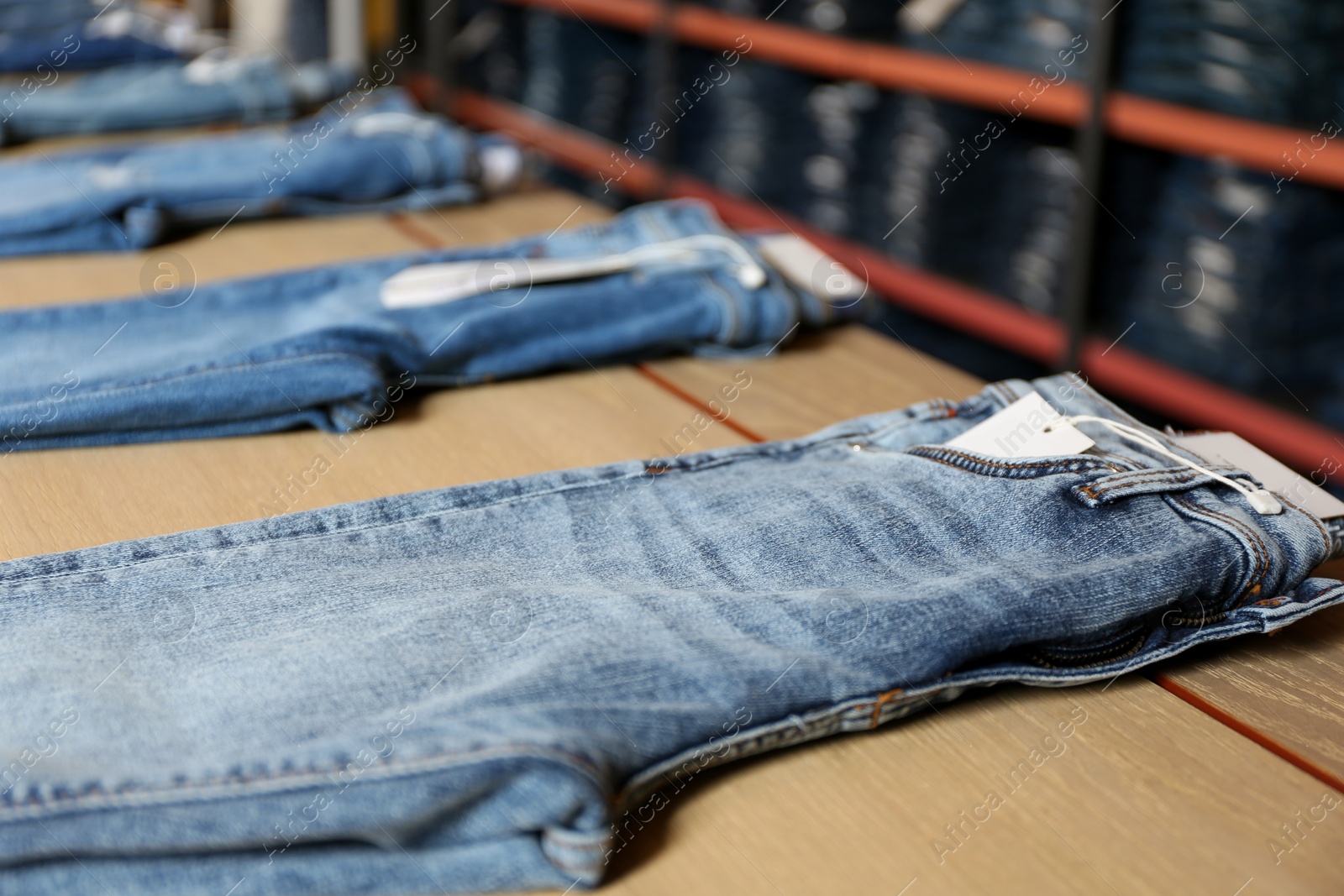 Photo of Stylish blue jeans on display in shop