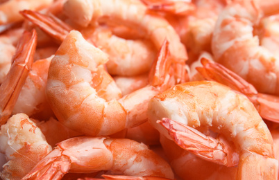 Photo of Pile of delicious peeled shrimps as background, closeup