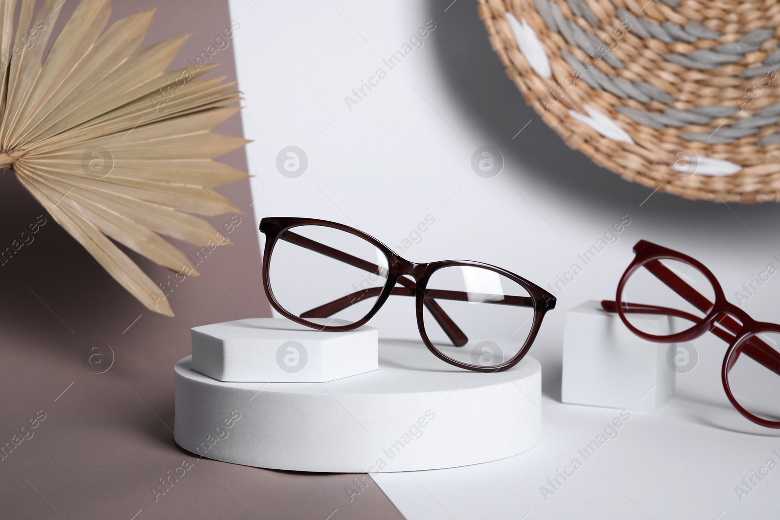 Photo of Stylish presentation of different glasses on color background