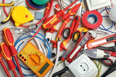 Set of electrician's tools on table, top view