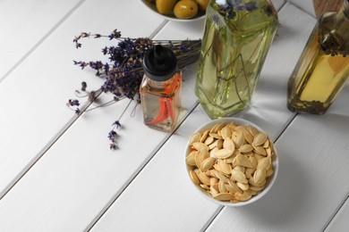 Photo of Different cooking oils and ingredients on white wooden table