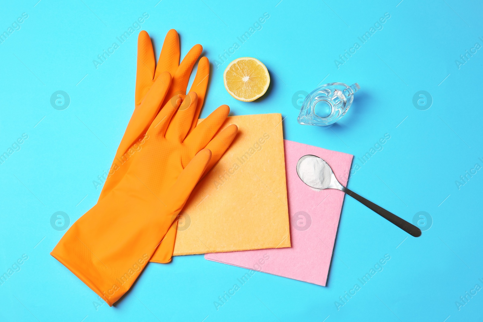 Photo of Flat lay composition with vinegar and cleaning supplies on color background