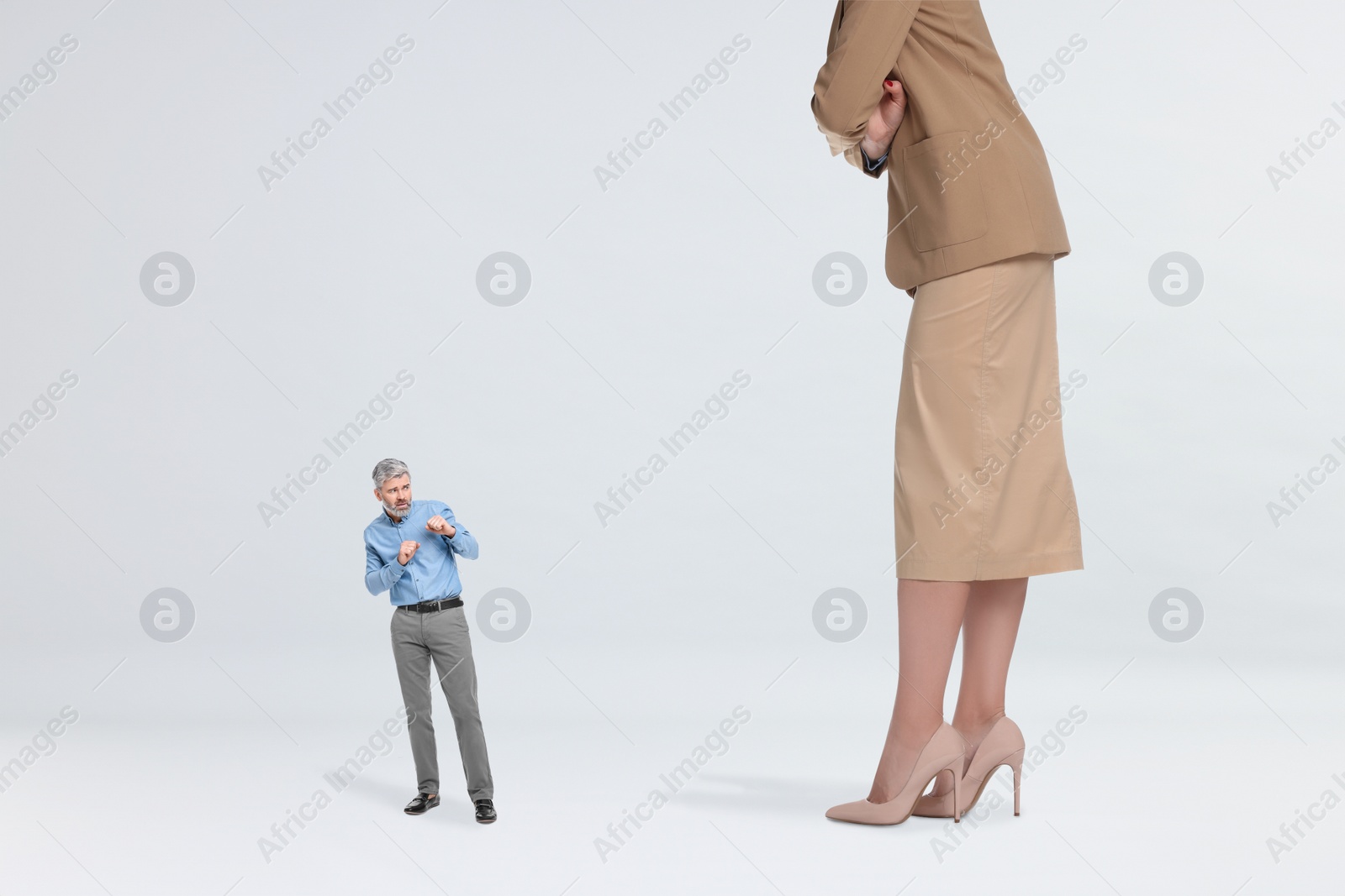 Image of Giant woman and small man on light background