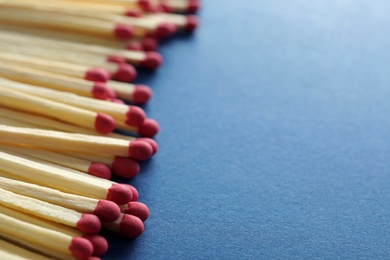 Photo of Many matches on color background, closeup. Space for text