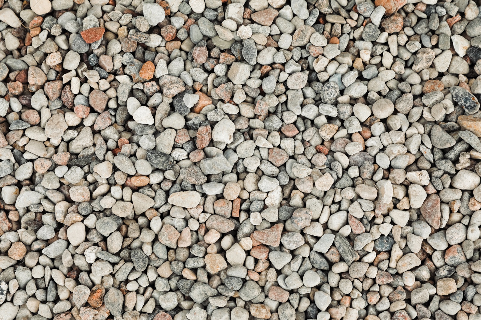 Photo of Pile of grey stones as background, top view