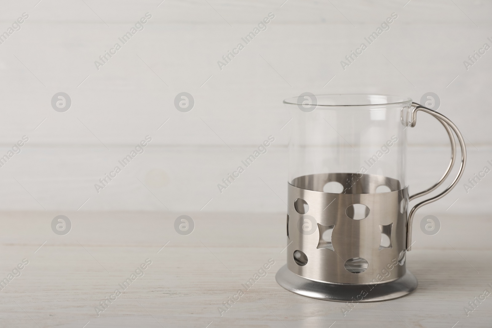 Photo of Traditional tea glass holder on wooden table, space for text