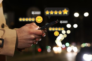 Image of Man leaving service feedback with smartphone outdoors, closeup. Stars and emoticons near device