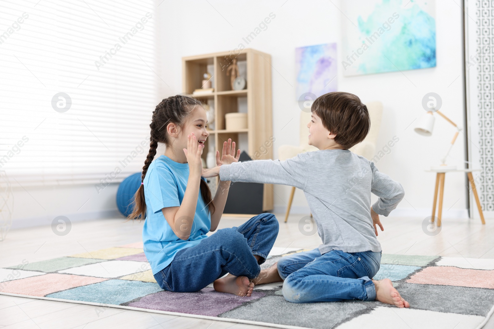 Photo of Happy brother and sister spending time together at home