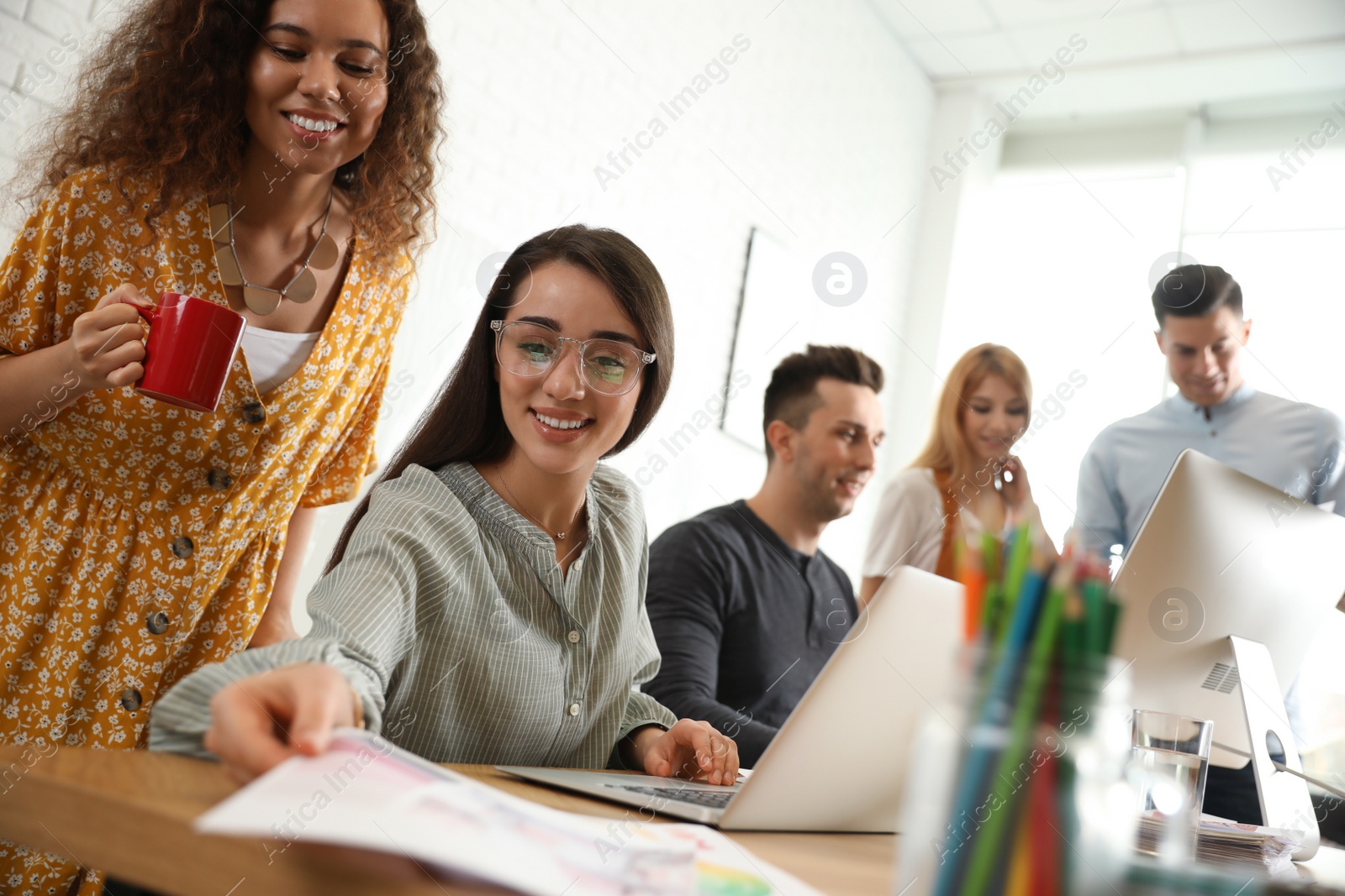 Photo of Team of professional designers working in office