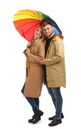 Full length portrait of beautiful couple with umbrella, isolated on white