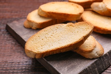 Tasty hard chuck crackers on wooden table, closeup