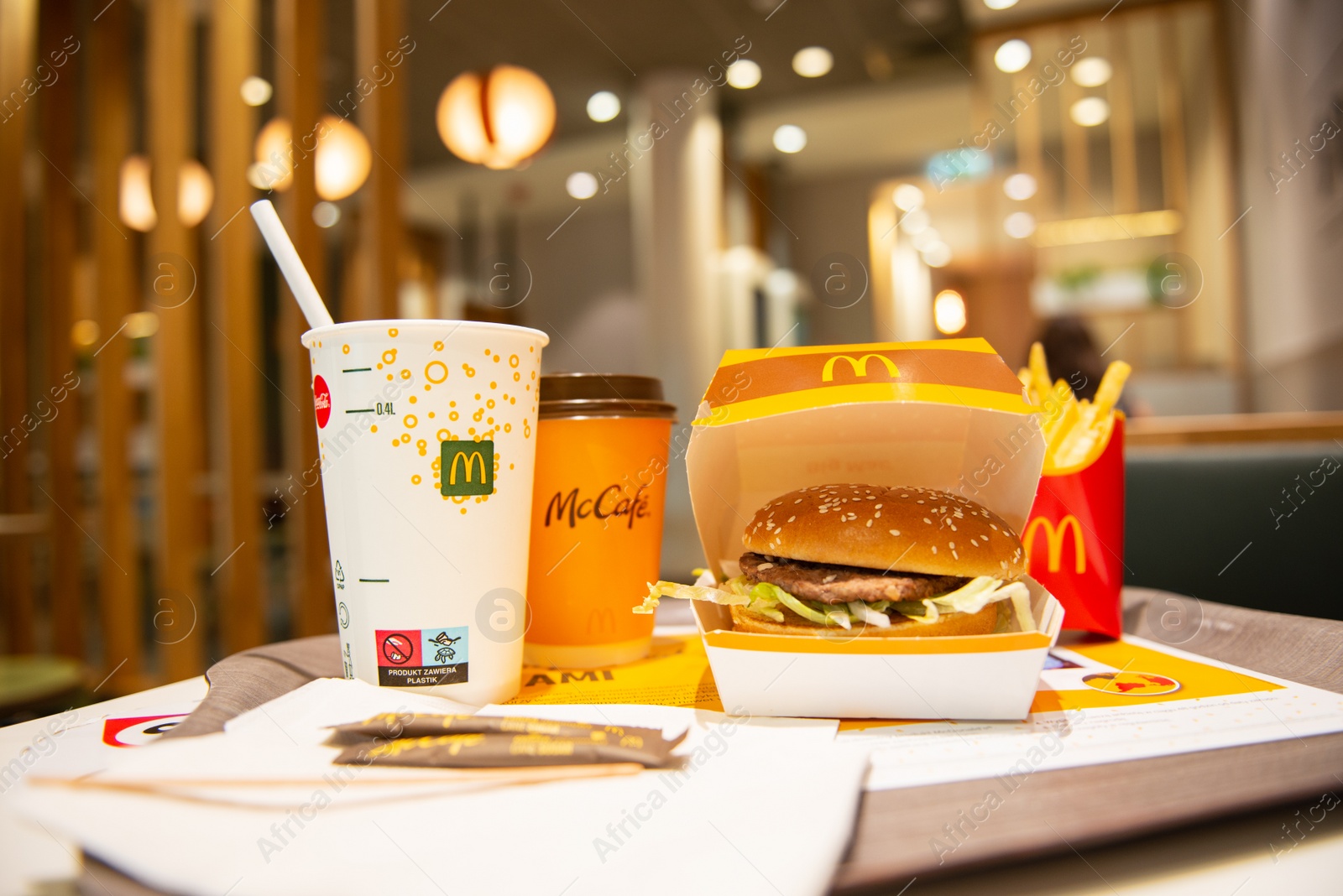 Photo of WARSAW, POLAND - SEPTEMBER 04, 2022: McDonald's French fries, burger and drinks on table indoors