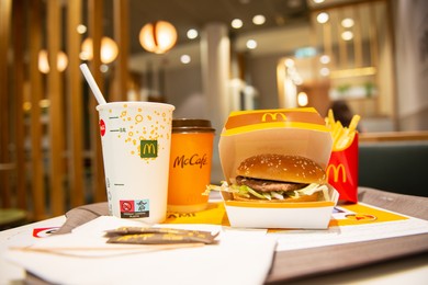 WARSAW, POLAND - SEPTEMBER 04, 2022: McDonald's French fries, burger and drinks on table indoors