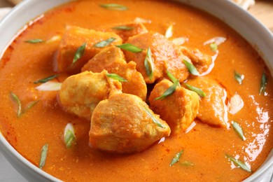 Photo of Bowl of delicious chicken curry, closeup view